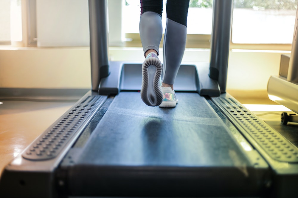 exercise stress test - close up of someone walking on treadmill